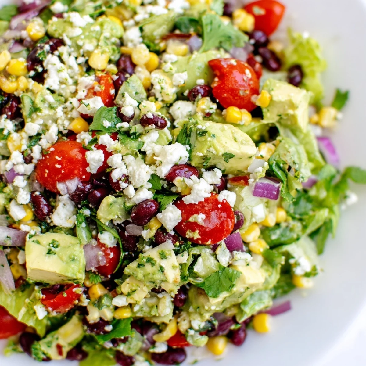 Mexican chopped salad featuring crisp lettuce tomatoes corn avocado and black beans