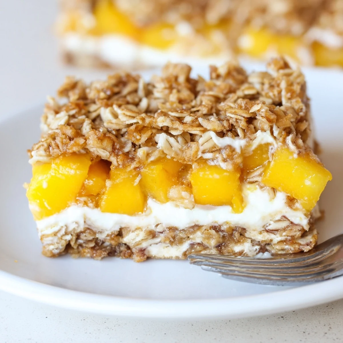 Golden Peaches And Cream Crumble Bars sliced neatly on a rustic wooden cutting board