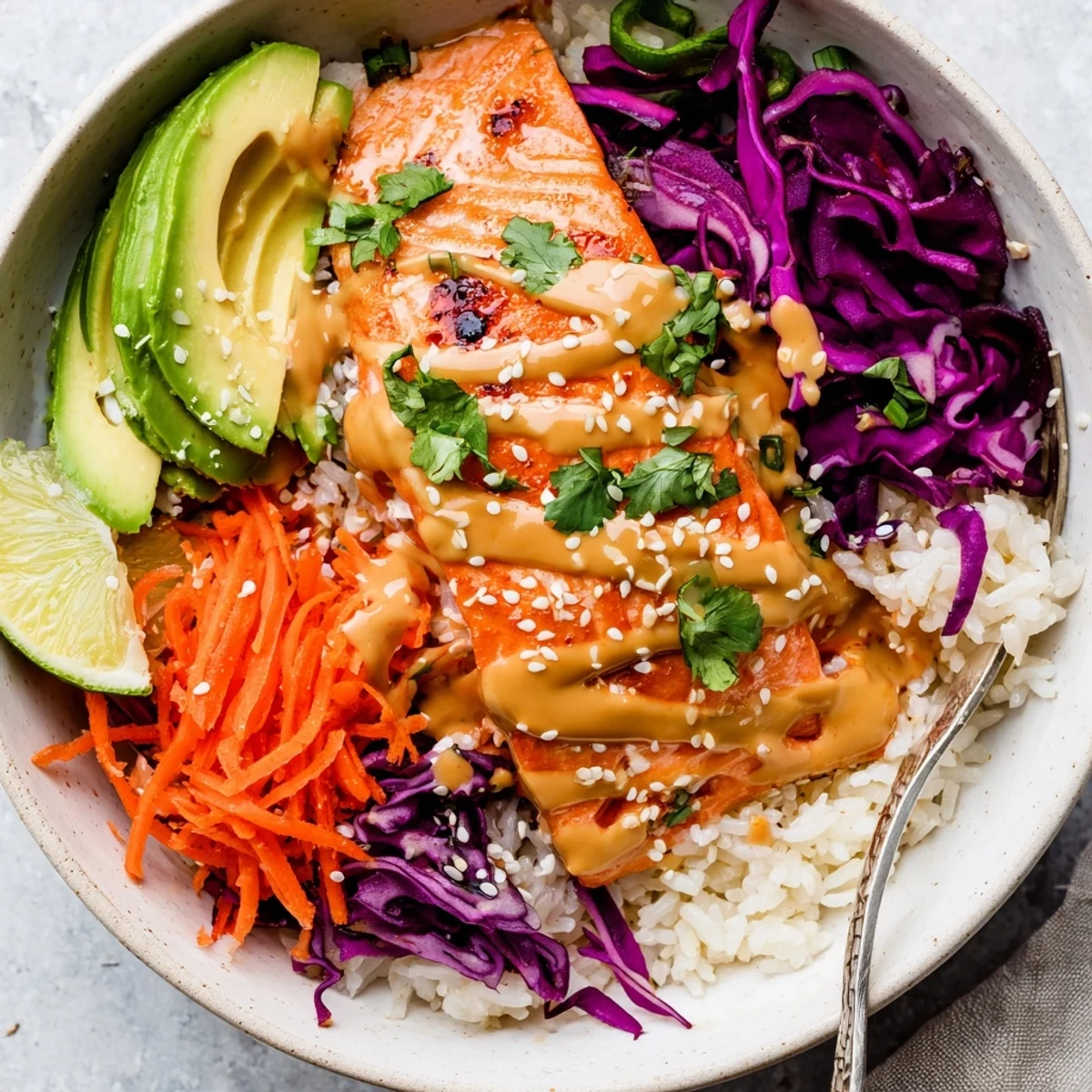 Bang Bang Salmon Bowls Recipe with roasted salmon, fluffy jasmine rice, bright veggies.