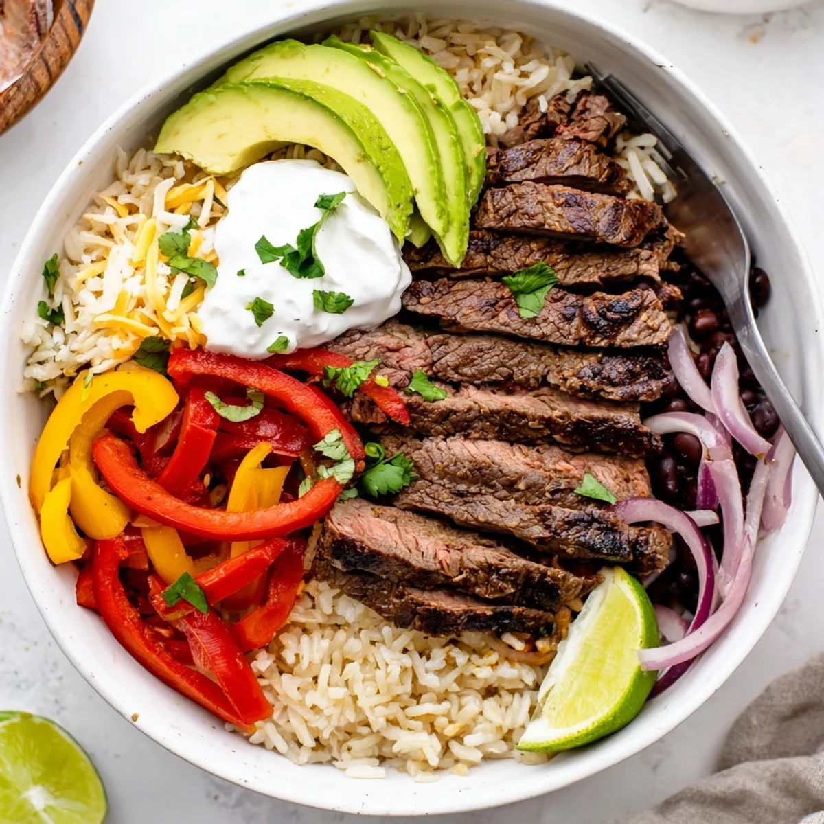 Warm brown rice, creamy avocado, and Steak Fajita Power Bowls ready to eat