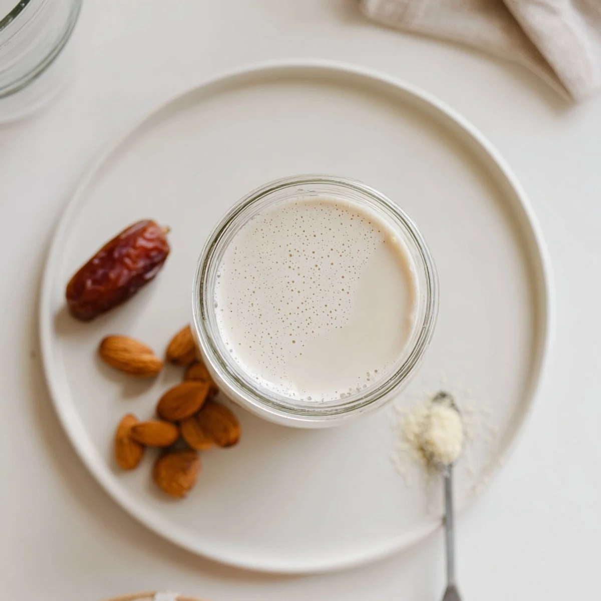 Creamy homemade Almond Milk in glass jar, perfect for coffee or cereal