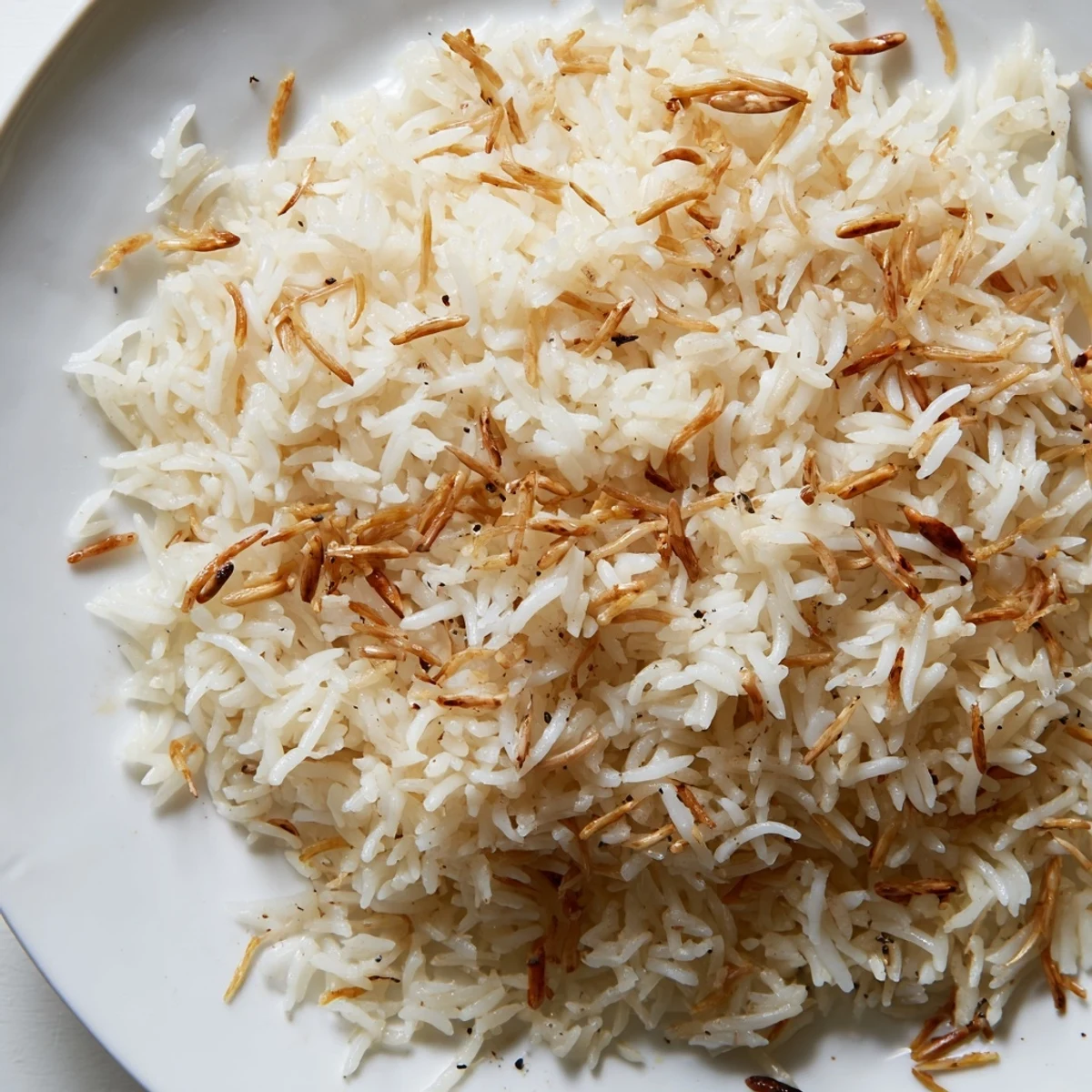 Fluffy Lebanese rice steamed with buttery noodles topped with crunchy pine nuts