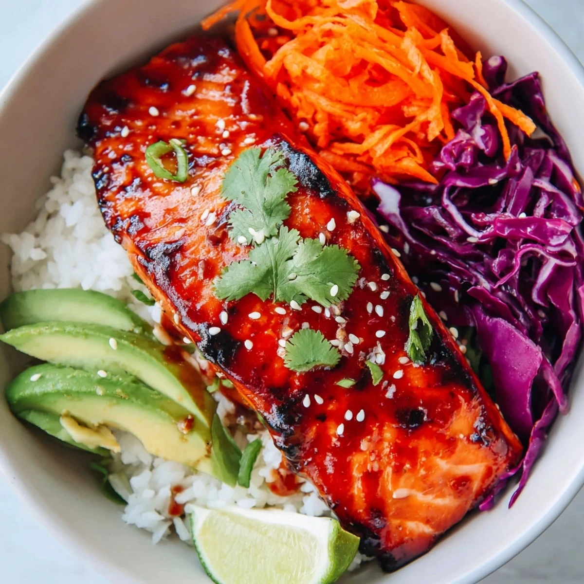 Golden glazed salmon fillet served over rice with colorful crunchy vegetables and sesame seed garnish