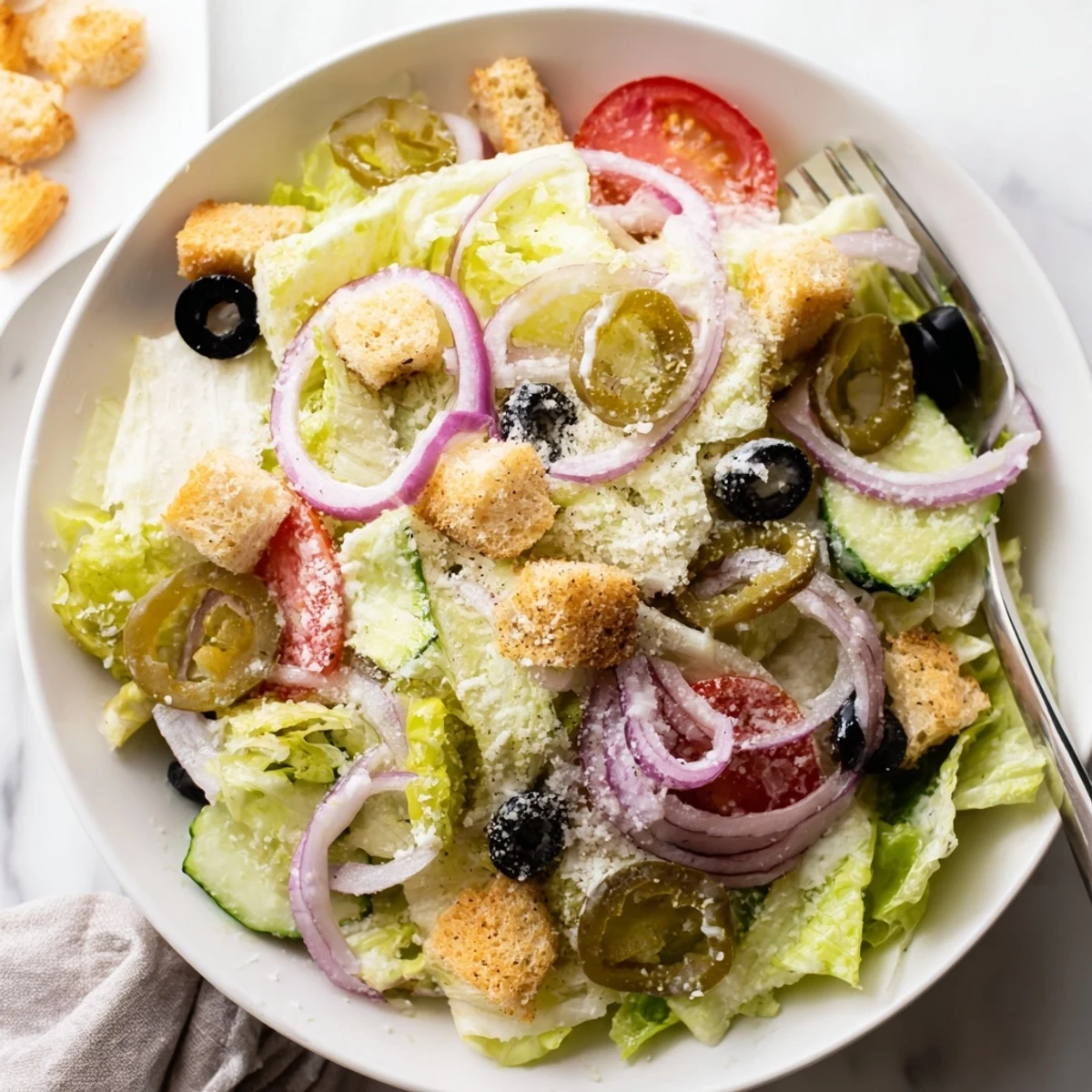 Crisp Olive Garden Salad topped with croutons and creamy Parmesan dressing