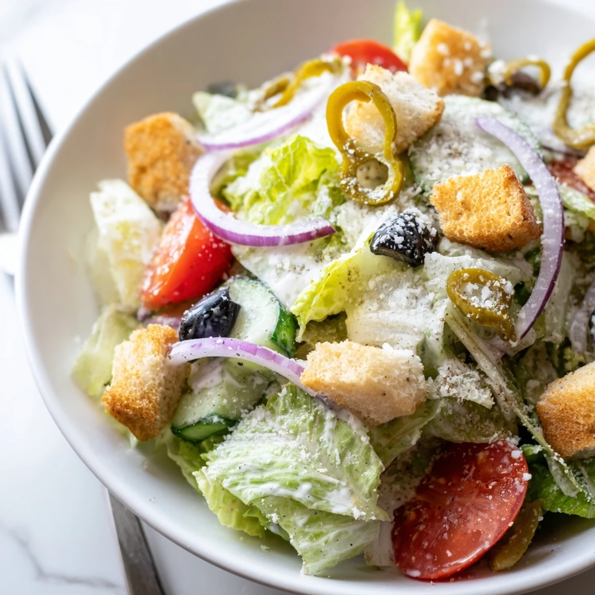 Fresh Olive Garden Salad with vibrant tomatoes, olives, and pepperoncini peppers