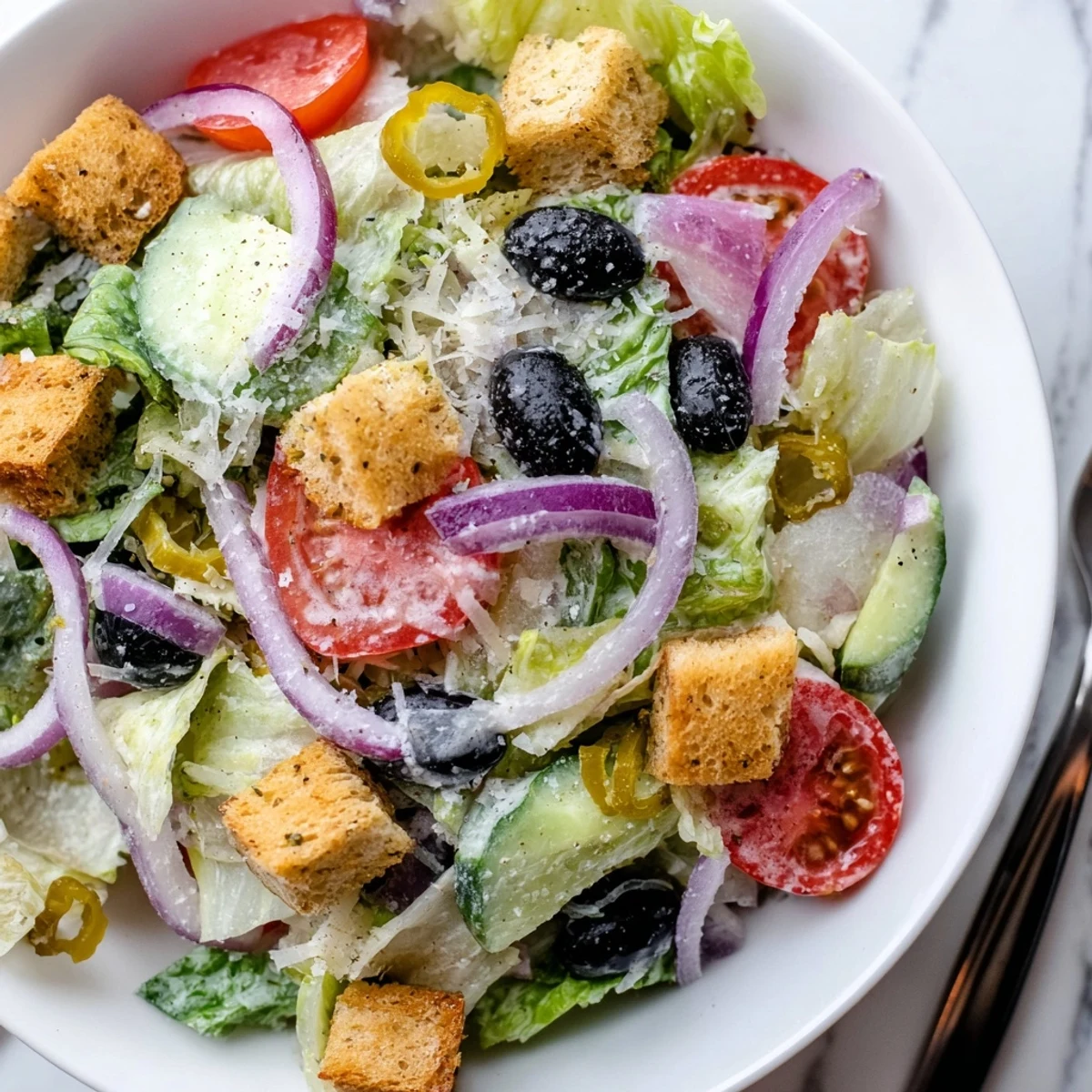 Tangy Italian-dressed Olive Garden Salad served in a rustic wooden bowl