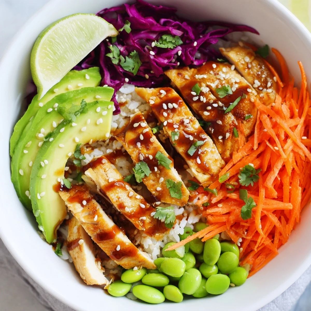 Golden seared Asian Inspired Chicken Power Bowl with crisp vegetables and sesame dressing
