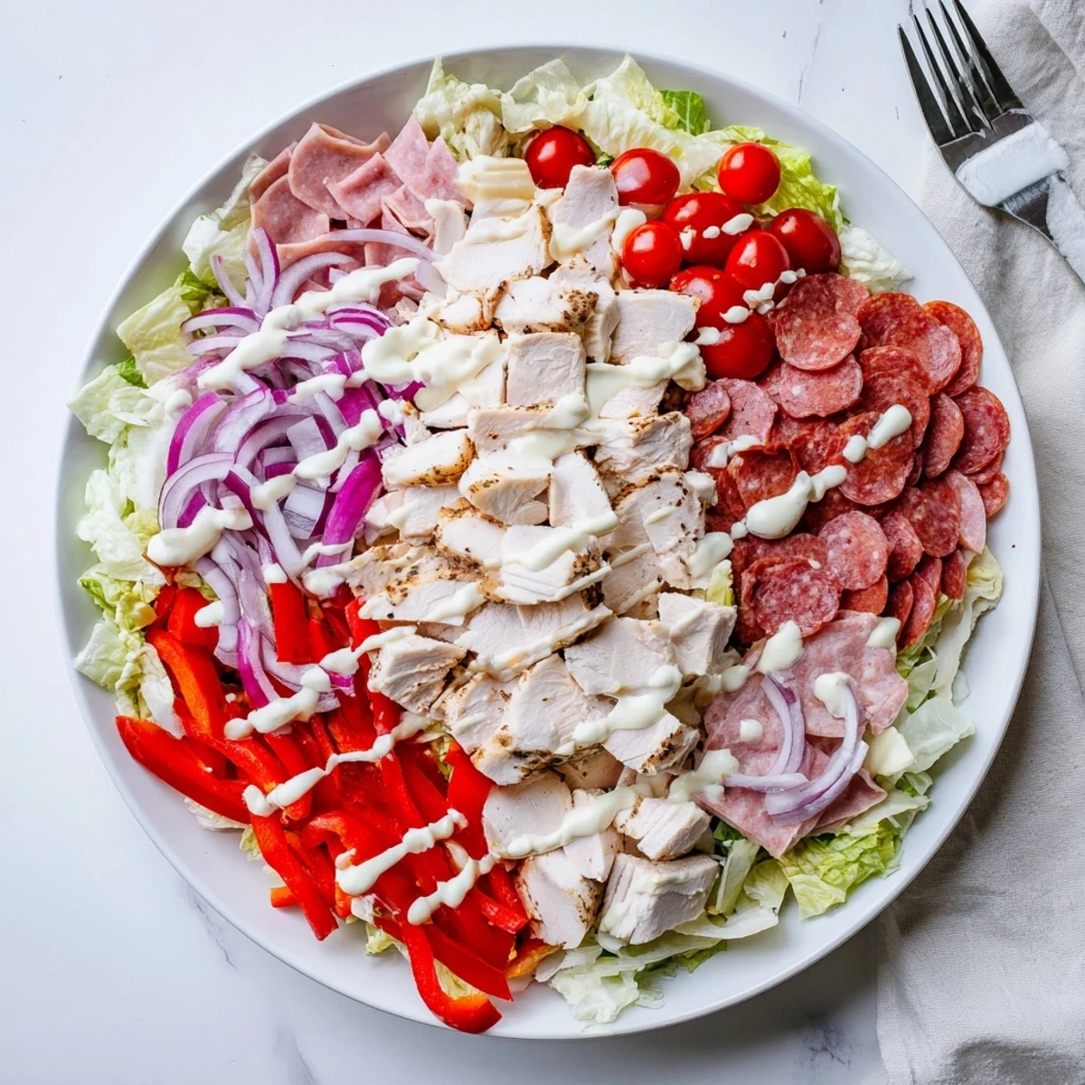 Protein-packed Italian grinder chicken salad featuring grilled chicken, deli meats, and tangy homemade dressing.