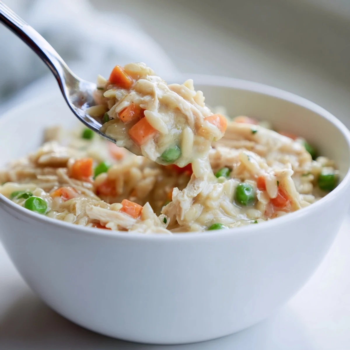 Creamy chicken pot pie orzo features tender chunks of chicken and colorful vegetables in a rich sauce.